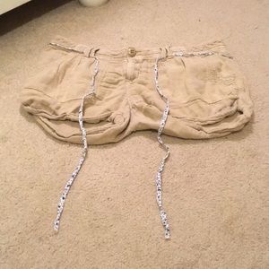 Arie khaki shorts with blue flower fabric belt.